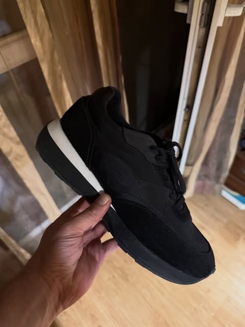 Black suede sneaker with a white midsole
